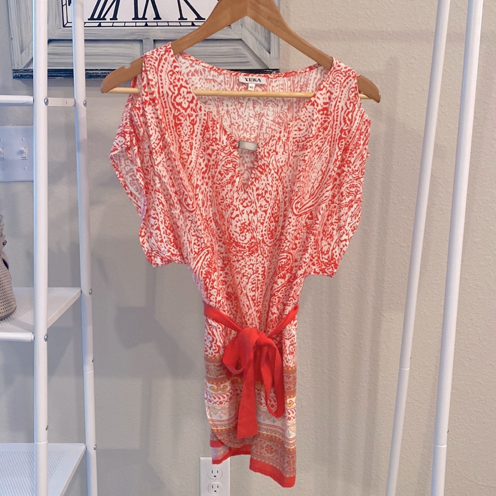 Yuka blouse in size 40. Pink and white flower design with tie at bottom.